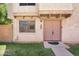 Front exterior with a decorative door, window, and manicured lawn at 600 S Dobson Rd # 178, Mesa, AZ 85202