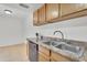 Kitchen featuring tile floors, wood cabinets, laminate counters, and stainless sink at 600 S Dobson Rd # 178, Mesa, AZ 85202
