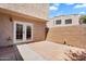 Private outdoor patio featuring block wall, tile pavers, and double door entry at 600 S Dobson Rd # 178, Mesa, AZ 85202