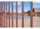 Community pool with lounge seating and secure fencing in residential area at 600 S Dobson Rd # 178, Mesa, AZ 85202