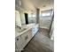 Modern bathroom with double sink vanity, quartz counters, and tile floors at 6262 S Dean Rd, Buckeye, AZ 85326