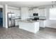 Modern kitchen featuring stainless steel appliances, an island, and tile floors at 6262 S Dean Rd, Buckeye, AZ 85326