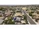 An aerial neighborhood view showcasing homes with solar panels and backyard pools at 651 W Cobblestone Dr, Casa Grande, AZ 85122