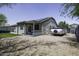 Backyard with covered patio, solar panels, and a trailer parked in the driveway at 651 W Cobblestone Dr, Casa Grande, AZ 85122