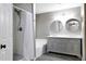 Bathroom with a shower, tub, and double sink vanity with granite counters and modern fixtures at 651 W Cobblestone Dr, Casa Grande, AZ 85122