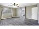 Bedroom featuring a window, ceiling fan, wood-look floors, and attached bath at 651 W Cobblestone Dr, Casa Grande, AZ 85122