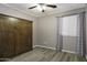 Bedroom with murphy bed, ceiling fan, window, and grey walls at 651 W Cobblestone Dr, Casa Grande, AZ 85122