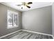 Bedroom with wood-look floors, window and ceiling fan at 651 W Cobblestone Dr, Casa Grande, AZ 85122