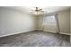 Bedroom with a window, ceiling fan, neutral paint and wood-look floors at 651 W Cobblestone Dr, Casa Grande, AZ 85122