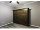 Bedroom with murphy bed, ceiling fan, and grey walls at 651 W Cobblestone Dr, Casa Grande, AZ 85122