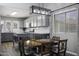 Charming dining area featuring a rustic wood table, modern light fixture, and seamless access to the kitchen at 651 W Cobblestone Dr, Casa Grande, AZ 85122