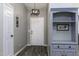 Welcoming entryway showcasing wood-look floors, gray walls, a stylish light fixture, and a built-in shelf at 651 W Cobblestone Dr, Casa Grande, AZ 85122