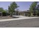Lovely single-story home featuring a spacious driveway, desert landscaping, and mature trees at 651 W Cobblestone Dr, Casa Grande, AZ 85122