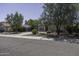 Attractive single-story home featuring desert landscaping, mature trees, and a spacious driveway at 651 W Cobblestone Dr, Casa Grande, AZ 85122