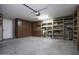 Large two car garage with built in cabinets and wood shelves for organized storage at 651 W Cobblestone Dr, Casa Grande, AZ 85122
