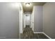Hallway with wood-look floors, neutral paint, and white trim at 651 W Cobblestone Dr, Casa Grande, AZ 85122