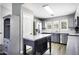 Kitchen featuring grey cabinets, an island, stainless steel appliances, and wood-look flooring at 651 W Cobblestone Dr, Casa Grande, AZ 85122