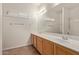 A bright bathroom features a double sink vanity, and a large mirror, enhanced by natural light at 6787 W Saddlehorn Rd, Peoria, AZ 85383