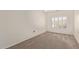 Bright bedroom with neutral carpet and a window, providing a serene space at 6787 W Saddlehorn Rd, Peoria, AZ 85383