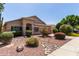 Inviting front yard with colorful bushes, desert landscaping, and a charming pathway at 6787 W Saddlehorn Rd, Peoria, AZ 85383