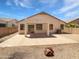 Rear exterior view of the home featuring a covered patio, ample backyard space, and desert landscaping at 7316 E Fledgling Dr, Scottsdale, AZ 85255