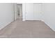 Bedroom featuring carpet, white walls and sliding door closet providing ample storage space at 7316 E Fledgling Dr, Scottsdale, AZ 85255