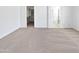 Neutral carpet and white walls in a bedroom with open walk-in closet and bathroom at 7316 E Fledgling Dr, Scottsdale, AZ 85255