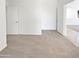 Well-lit bedroom with neutral carpet, white walls, and open doorway to create a serene atmosphere at 7316 E Fledgling Dr, Scottsdale, AZ 85255