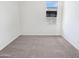 Clean bedroom featuring neutral carpet, white walls, and a bright window at 7316 E Fledgling Dr, Scottsdale, AZ 85255