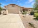 Charming single-story home featuring a two-car garage and desert landscaping at 7316 E Fledgling Dr, Scottsdale, AZ 85255