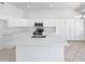 Modern kitchen with white cabinets, a spacious island, and stainless steel appliances at 7316 E Fledgling Dr, Scottsdale, AZ 85255