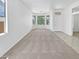 Bright living room featuring plush carpeting, large windows, and neutral paint, perfect for comfortable living at 7316 E Fledgling Dr, Scottsdale, AZ 85255