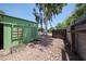 View of gravel backyard featuring a green painted shed, desert landscaping, and privacy walls at 759 W Los Lagos Vista Ave, Mesa, AZ 85210