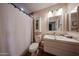 Cozy bathroom featuring a vanity with sink, medicine cabinet, and a shower with a curtain at 759 W Los Lagos Vista Ave, Mesa, AZ 85210