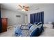 Bedroom featuring a comfortable bed with blue and white patterned bedding and a ceiling fan at 759 W Los Lagos Vista Ave, Mesa, AZ 85210