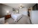 Bedroom featuring plush carpeting, ceiling fan, and built-in storage, offering comfort and convenience at 759 W Los Lagos Vista Ave, Mesa, AZ 85210