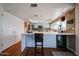 Eat-in kitchen with stainless steel appliances, and a charming breakfast bar at 759 W Los Lagos Vista Ave, Mesa, AZ 85210
