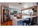 Bright eat-in kitchen with stainless appliances, breakfast bar, and charming modern blue cabinets at 759 W Los Lagos Vista Ave, Mesa, AZ 85210
