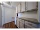 Laundry room with white cabinets and countertop for folding and sorting clothes at 759 W Los Lagos Vista Ave, Mesa, AZ 85210