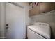 Functional laundry area with a modern washing machine and cabinets above for storage at 759 W Los Lagos Vista Ave, Mesa, AZ 85210