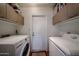 Laundry area with washer, dryer, door and upper cabinets at 759 W Los Lagos Vista Ave, Mesa, AZ 85210