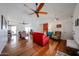 Bright living room with hardwood floors, ceiling fan, and access to multiple rooms at 759 W Los Lagos Vista Ave, Mesa, AZ 85210