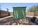 Gravel backyard featuring a green painted shed, privacy walls, and minimal desert landscaping at 759 W Los Lagos Vista Ave, Mesa, AZ 85210