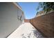 View of the side yard featuring a concrete walking surface, a privacy fence, and gravel landscaping at 759 W Los Lagos Vista Ave, Mesa, AZ 85210