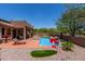 Lounge chairs and a mountain view surround a serene pool and backyard area, perfect for relaxing and entertaining at 7762 E Russell Cir, Mesa, AZ 85207