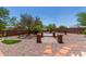 Picturesque backyard featuring a putting green, stone pathway, lush landscaping, and privacy fence at 7762 E Russell Cir, Mesa, AZ 85207