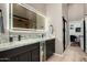 The updated bathroom showcases double sinks, granite countertops, and modern lighting at 7762 E Russell Cir, Mesa, AZ 85207