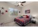 Charming bedroom with patriotic decor, a ceiling fan, and natural light from the window at 7762 E Russell Cir, Mesa, AZ 85207