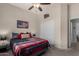 Cozy bedroom with patriotic decor, a ceiling fan, and carpet at 7762 E Russell Cir, Mesa, AZ 85207