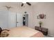 Bright bedroom with a queen-sized bed, closet with white doors, soft neutral tones and a view through to the kitchen at 7762 E Russell Cir, Mesa, AZ 85207